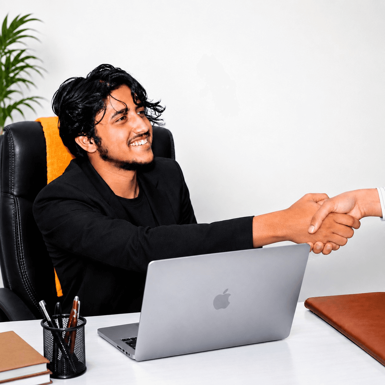 Mr. Amir Khan, Founder and Director of WEFOI, greeting a partner across the workshop desk