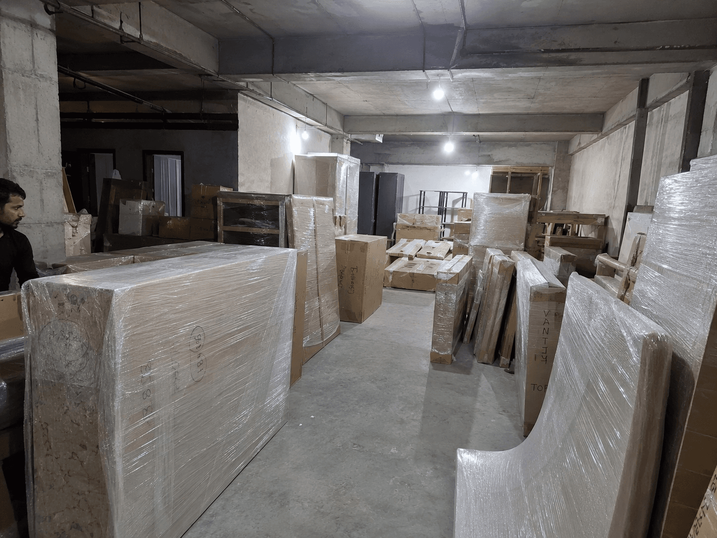 WEFOI manufacturing floor with finished furniture wrapped and prepared for delivery